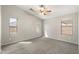 Light-filled bedroom with a vaulted ceiling, fan, and multiple windows at 2523 W Running Deer Trl, Phoenix, AZ 85085