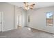 Spacious bedroom with a ceiling fan, carpet flooring and natural light coming through the windows at 2523 W Running Deer Trl, Phoenix, AZ 85085