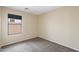 Cozy bedroom with neutral walls, carpet, and a window offering natural light at 2523 W Running Deer Trl, Phoenix, AZ 85085