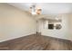 Open-concept living area with a ceiling fan, wood-look floors, and views into the kitchen at 2523 W Running Deer Trl, Phoenix, AZ 85085