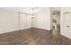 Neutral living space features wood-look floors, with archway to kitchen and open access to other rooms at 2523 W Running Deer Trl, Phoenix, AZ 85085