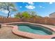 Backyard view of a private pool with a red concrete border, surrounded by an easy to maintain gravel yard at 2523 W Running Deer Trl, Phoenix, AZ 85085