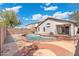 Backyard view of a private pool with a red concrete border, surrounded by an easy to maintain gravel yard at 2523 W Running Deer Trl, Phoenix, AZ 85085