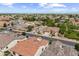 Overhead view of a neighborhood with landscaped yards, uniform housing styles, and orderly streets under a bright, sunny sky at 2664 E Ebony Dr, Chandler, AZ 85286