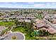 Community aerial shot showing manicured lawns, tiled roofs, and inviting green spaces, set against distant mountain views at 2664 E Ebony Dr, Chandler, AZ 85286