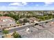 Expansive aerial view of a well-maintained neighborhood featuring tile roofs and green landscaping under a partly cloudy sky at 2664 E Ebony Dr, Chandler, AZ 85286