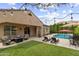 Inviting backyard oasis featuring a sparkling pool, comfortable seating, and meticulously maintained landscaping at 2664 E Ebony Dr, Chandler, AZ 85286