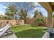 Spacious backyard with lush synthetic grass, mature trees, and a serene, private atmosphere at 2664 E Ebony Dr, Chandler, AZ 85286