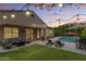 Outdoor backyard oasis features a swimming pool, lounge chairs, patio furniture, string lights, and manicured landscaping at 2664 E Ebony Dr, Chandler, AZ 85286