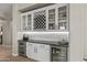 Custom wet bar featuring wine storage, glass cabinets, and beverage refrigerators, perfect for entertaining at 2664 E Ebony Dr, Chandler, AZ 85286