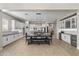 Open kitchen and dining area with white cabinets, black countertops, stainless appliances, and a dining table with seating at 2664 E Ebony Dr, Chandler, AZ 85286