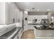 Kitchen view featuring white cabinets, dark countertops, backsplash, stainless steel appliances, and an island at 2664 E Ebony Dr, Chandler, AZ 85286