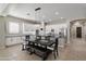 Bright kitchen boasts white cabinetry, stainless steel appliances, a large island, and an elegant dining table at 2664 E Ebony Dr, Chandler, AZ 85286
