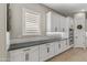 Kitchen showcasing white cabinetry, dark countertops, tiled backsplash, and modern appliances at 2664 E Ebony Dr, Chandler, AZ 85286