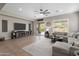 Spacious living room offers a comfortable sectional sofa, large television, and sliding doors leading to the pool at 2664 E Ebony Dr, Chandler, AZ 85286