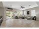 Spacious living room with tile flooring, a large sectional sofa, and a sliding glass door to the outdoor patio at 2664 E Ebony Dr, Chandler, AZ 85286