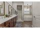 Elegant main bathroom featuring dual sinks, a glass-enclosed shower, and a freestanding soaking tub at 2664 E Ebony Dr, Chandler, AZ 85286