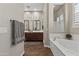 The main bathroom boasts a soaking tub and dual vanities with framed mirrors at 2664 E Ebony Dr, Chandler, AZ 85286
