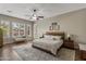 Bright main bedroom features a cozy seating area, a ceiling fan and windows with shutter-style blinds at 2664 E Ebony Dr, Chandler, AZ 85286