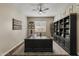 View of the office with a large black desk, built-in shelves, and a window with white shutters at 2664 E Ebony Dr, Chandler, AZ 85286