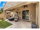 Relaxing covered patio with comfortable seating, ceiling fans, and a view of the well-maintained backyard at 2664 E Ebony Dr, Chandler, AZ 85286