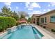 Gorgeous pool with water feature, red patio umbrella, and privacy landscaping at 2664 E Ebony Dr, Chandler, AZ 85286
