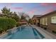 Backyard pool, lounge chairs, umbrella, privacy landscaping, and covered patio at 2664 E Ebony Dr, Chandler, AZ 85286