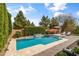 Sparkling pool with serene privacy provided by towering hedges and lush trees at 2664 E Ebony Dr, Chandler, AZ 85286