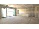 Living room showcases natural light streaming through the sliding glass door, awaiting finishing touches at 32139 N Lone Rancher Way, San Tan Valley, AZ 85140