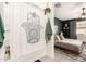 Modern bathroom with stylish shower curtain and adjacent bedroom with neutral paint and decor at 3219 W Pollack St, Phoenix, AZ 85041