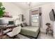 Neutral guest bedroom with a desk, closet, gray-green bedding and a large window at 3219 W Pollack St, Phoenix, AZ 85041
