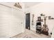 Eclectic bedroom featuring a gray sliding door closet, dark door, and decorated shelves with musical instruments at 3219 W Pollack St, Phoenix, AZ 85041