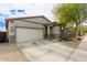 This lovely home features a two-car garage and charming desert landscaping, creating a welcoming exterior at 3219 W Pollack St, Phoenix, AZ 85041