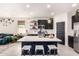 Bright kitchen with an island featuring a seating area and open views into the living room and dining space at 3219 W Pollack St, Phoenix, AZ 85041