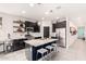 Contemporary kitchen with a spacious island, stainless steel appliances, and open shelving for stylish storage at 3219 W Pollack St, Phoenix, AZ 85041