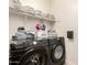 Laundry room with high capacity Samsung washer and dryer and shelving with storage bins at 3219 W Pollack St, Phoenix, AZ 85041