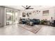 Bright living room with a comfortable blue sofa, stylish decor, and a view of the backyard pool at 3219 W Pollack St, Phoenix, AZ 85041