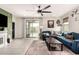 Inviting living room with a comfortable blue sectional sofa and sliding doors to the backyard pool at 3219 W Pollack St, Phoenix, AZ 85041