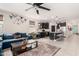 Open-concept living space with blue sofa and stylish decor flowing into the kitchen with a large island at 3219 W Pollack St, Phoenix, AZ 85041