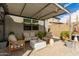 Shaded outdoor living area with comfortable chairs and modern accents at 3219 W Pollack St, Phoenix, AZ 85041