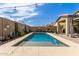 Backyard view of a swimming pool featuring a tanning ledge and string lights at 3219 W Pollack St, Phoenix, AZ 85041