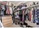 Spacious walk-in closet with custom shelves, hanging racks and wooden drawers at 3219 W Pollack St, Phoenix, AZ 85041