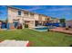 Backyard featuring a pool, artificial grass and lounge furniture at 3708 S 104Th Ln, Tolleson, AZ 85353
