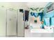 Bathroom featuring a tub with shower and colorful wallpaper art at 3708 S 104Th Ln, Tolleson, AZ 85353
