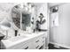 Bathroom featuring double sinks, a round mirror and decorative anchor at 3708 S 104Th Ln, Tolleson, AZ 85353