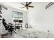 Spacious bedroom with a desk, chair, modern ceiling fan, and unique flooring at 3708 S 104Th Ln, Tolleson, AZ 85353