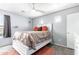 Well-lit bedroom with modern fan, gray walls, and white furniture at 3708 S 104Th Ln, Tolleson, AZ 85353