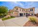 Spacious two-story home with a three car garage and a large driveway with desert landscaping at 3708 S 104Th Ln, Tolleson, AZ 85353
