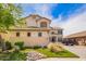Inviting two-story home featuring a well-manicured lawn, charming desert landscaping, and a convenient driveway at 3708 S 104Th Ln, Tolleson, AZ 85353