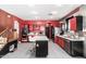 Spacious kitchen featuring red cabinets, ample countertop space, and stainless-steel appliances at 3708 S 104Th Ln, Tolleson, AZ 85353